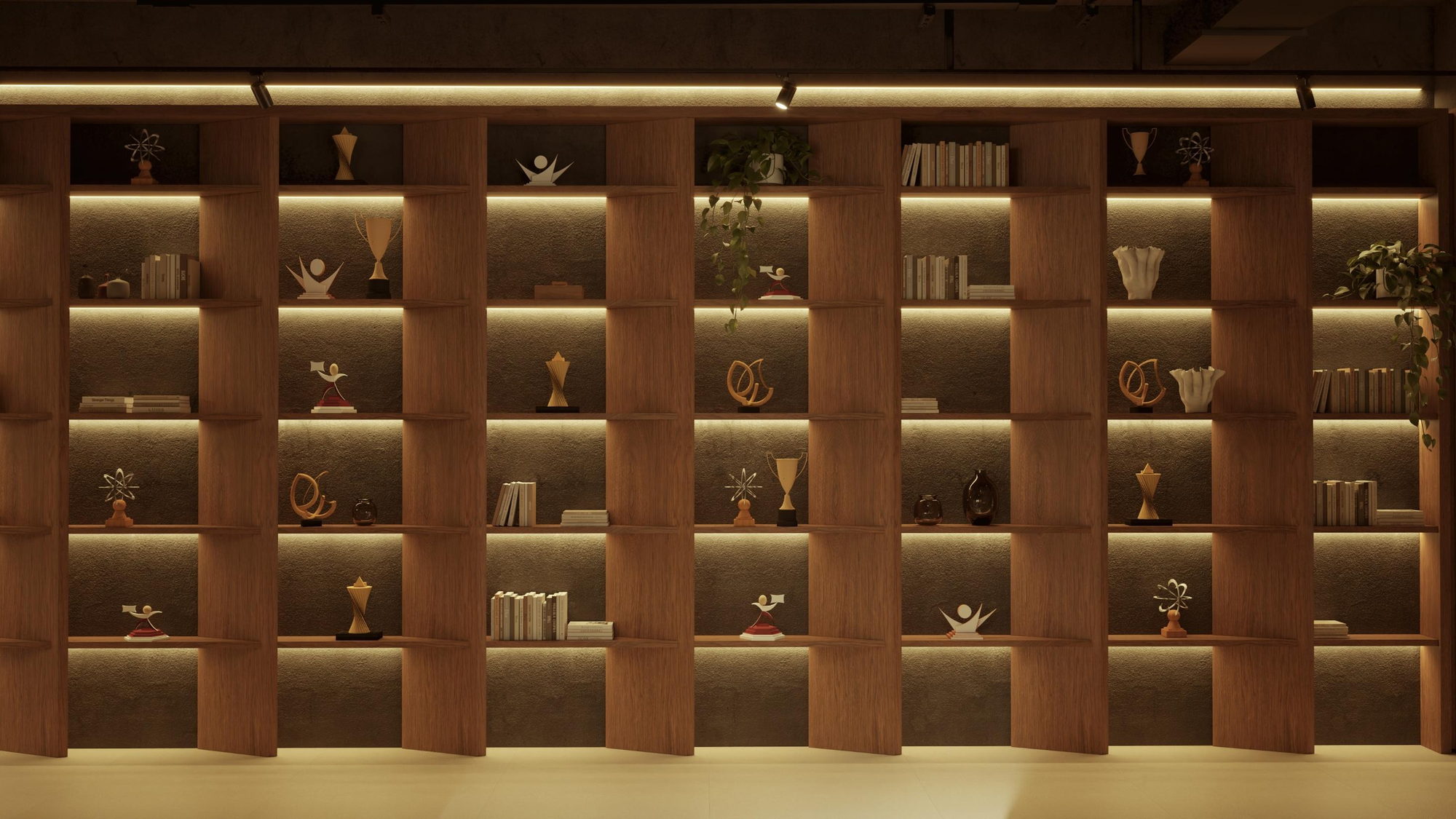 Parede inteira de prateleiras iluminadas com troféus da RE/MAX, livros e plantas.