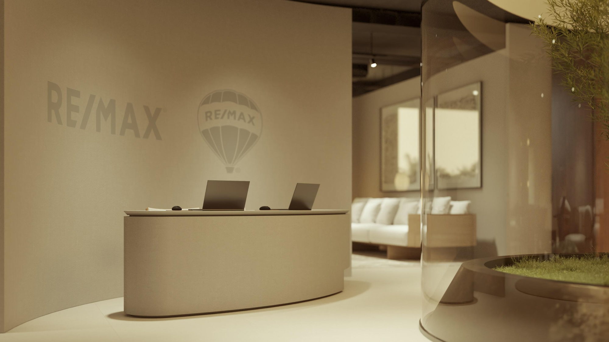 Recepção de uma loja RE/MAX, com a marca aplicada em tom sobre tom na parede de fundo.